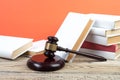 Law concept - Open law book with a wooden judges gavel on table in a courtroom or law enforcement office isolated on white Royalty Free Stock Photo