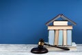 Law concept open book with wooden judges gavel on table in a courtroom or law enforcement office, blue background. Copy space for Royalty Free Stock Photo