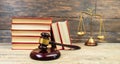 Law concept - Open law book, Judge\'s gavel, scales on table in a courtroom or law enforcement office Royalty Free Stock Photo