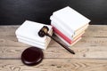 Law concept - Open law book with a wooden judges gavel on table in a courtroom or law enforcement office isolated on white Royalty Free Stock Photo