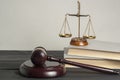 Law concept. Wooden judge gavel with law books ,scales of justice on table in a courtroom or enforcement office. Royalty Free Stock Photo