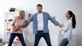 In-law conflict, mother and wife pulling young man in different directions