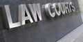 Law Courts sign in stainless steel, courthouse building Royalty Free Stock Photo