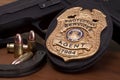 Law enforcement badge with gun, handcuffs and bullets