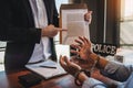 Law enforcement officer interrogating Criminals male with handcuffs in the investigation room Police officer interviewing after Royalty Free Stock Photo