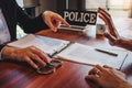 Law enforcement officer interrogating Criminals male with handcuffs in the investigation room Police officer interviewing after Royalty Free Stock Photo