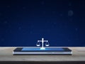 Law flat icon on modern smart mobile phone screen on wooden table over fantasy night sky and moon, Business legal service online Royalty Free Stock Photo