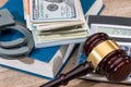 Law gavel with Dollars in book and handcuff Royalty Free Stock Photo