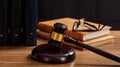 Judge gavel on a wooden desk, law books background Royalty Free Stock Photo