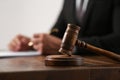 Law and justice. Closeup of judge working at wooden table, focus on gavel Royalty Free Stock Photo