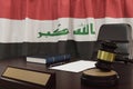 Law and justice concept,  gavel on a wooden desktop and the Iraq flag on background. 3d render Royalty Free Stock Photo