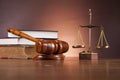 Law and justice stuff on wooden table, dark background Royalty Free Stock Photo