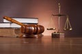 Law and justice stuff on wooden table, dark background Royalty Free Stock Photo