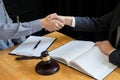 Law and Legal concept, Consultation between attorneys and clients customer shaking hands discussing contract agreement In