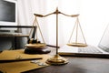 law legal technology concept. judge gavel on computer with scales of justice on desk of lawyer Royalty Free Stock Photo