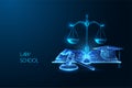 Law school, education concept with open book, gavel, scales and graduation cap on dark blue