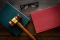 Law student concept. Judge gavel and vintage books on dark wooden background top view Royalty Free Stock Photo