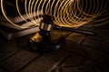 Law theme, mallet of the judge on wooden desk. Law gavel on dark foggy background with light Royalty Free Stock Photo