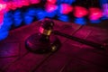 Law theme, mallet of the judge on wooden desk. Law gavel on dark foggy background with light Royalty Free Stock Photo