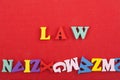 LAW word on red background composed from colorful abc alphabet block wooden letters, copy space for ad text. Learning english Royalty Free Stock Photo