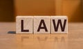 law - word in wooden blocks on wooden table Royalty Free Stock Photo