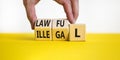 Lawful or illegal symbol. Concept word Lawful or Illegal on wooden cubes. Beautiful yellow table white background. Businessman