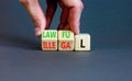 Lawful or illegal symbol. Concept word Lawful or Illegal on wooden cubes. Beautiful grey table grey background. Businessman hand.