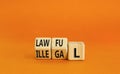 Lawful or illegal symbol. Concept word Lawful or Illegal on wooden cubes. Beautiful orange table orange background. Business