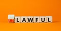 Lawful or unlawful symbol. Turned wooden cubes and changed the concept word Unlawful to Lawful. Beautiful orange table orange