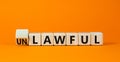 Lawful or unlawful symbol. Turned wooden cubes and changed the concept word Unlawful to Lawful. Beautiful orange table orange