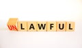 Lawful or unlawful symbol. Turned wooden cubes and changed the concept word Unlawful to Lawful. Beautiful white table white