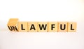 Lawful or unlawful symbol. Turned wooden cubes and changed the concept word Unlawful to Lawful. Beautiful white table white