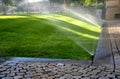 watering lawn automatic irrigation with pull-out sprinklers fresh green color black plastic nozzles extend and rotate in circular