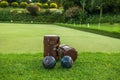 Lawn bowls leather bags and balls on the field side