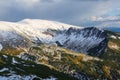 Lawn covered with white snow. Majestic spring sunny day. Beautiful landscape of high mountains and forests. Wallpaper background.