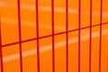 Lawn field for playing basketball behind the orange fence mesh. Metal mesh wire with tennis court. Royalty Free Stock Photo