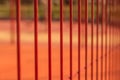 Lawn field for playing basketball behind the orange fence mesh. Metal mesh wire with tennis court. Royalty Free Stock Photo