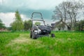 Lawn mover on green grass in modern garden. Machine for cutting lawns. Royalty Free Stock Photo