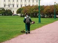 Lawn mower from the back at work. City service, maintenance of the city lawn in the Park.