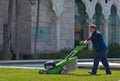 The lawn-mower behind work on street