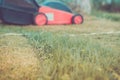 Lawn mower is cleaned from a grass/lawn mower is cleaned from a grass. Selective focus. Toned Royalty Free Stock Photo