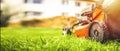 Lawn mower cut grass. Garden work. Electric Rotary lawn mower machine. Royalty Free Stock Photo