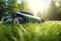 Lawn mower cutting green grass in backyard. Close-up of electric cordless lawn mower on the background of garden. Generative AI Royalty Free Stock Photo