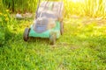 Lawn mower cutting green grass in backyard Royalty Free Stock Photo