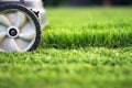 Lawn mower cutting green grass Royalty Free Stock Photo