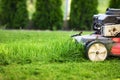 Lawn mower cutting green grass Royalty Free Stock Photo