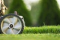 Lawn mower cutting green grass in sunlight Royalty Free Stock Photo