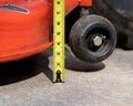 Lawn mower deck height adjustment and tape measure