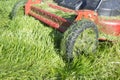 Lawn mower full of grass blades just after work Royalty Free Stock Photo