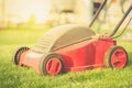 Lawn mower on the grass in the yard against sunshine/lawn mower on the grass in the yard against sunshine. Selective focus Royalty Free Stock Photo